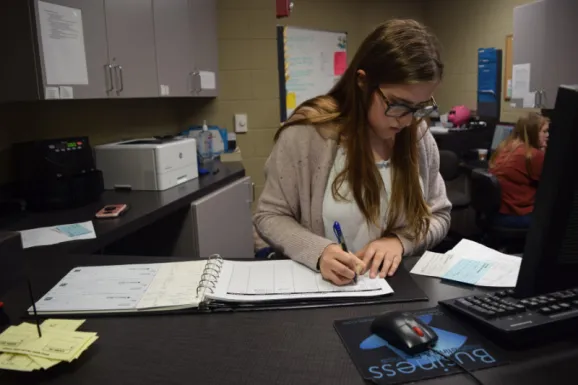 student doing paperwork at bank